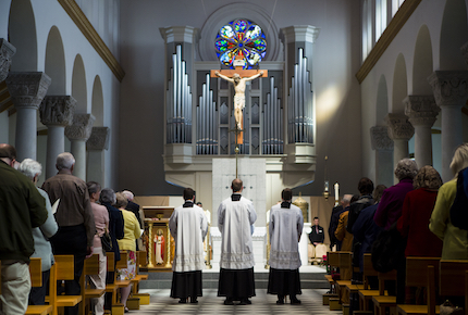 Priests stand in front of the alter while the closing song plays during the Friends Mass and Breakfast in Saint Mary's Chapel on Sunday, April 22, 2018.
