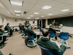 Seminarians sitting in a classroom learning from a professor