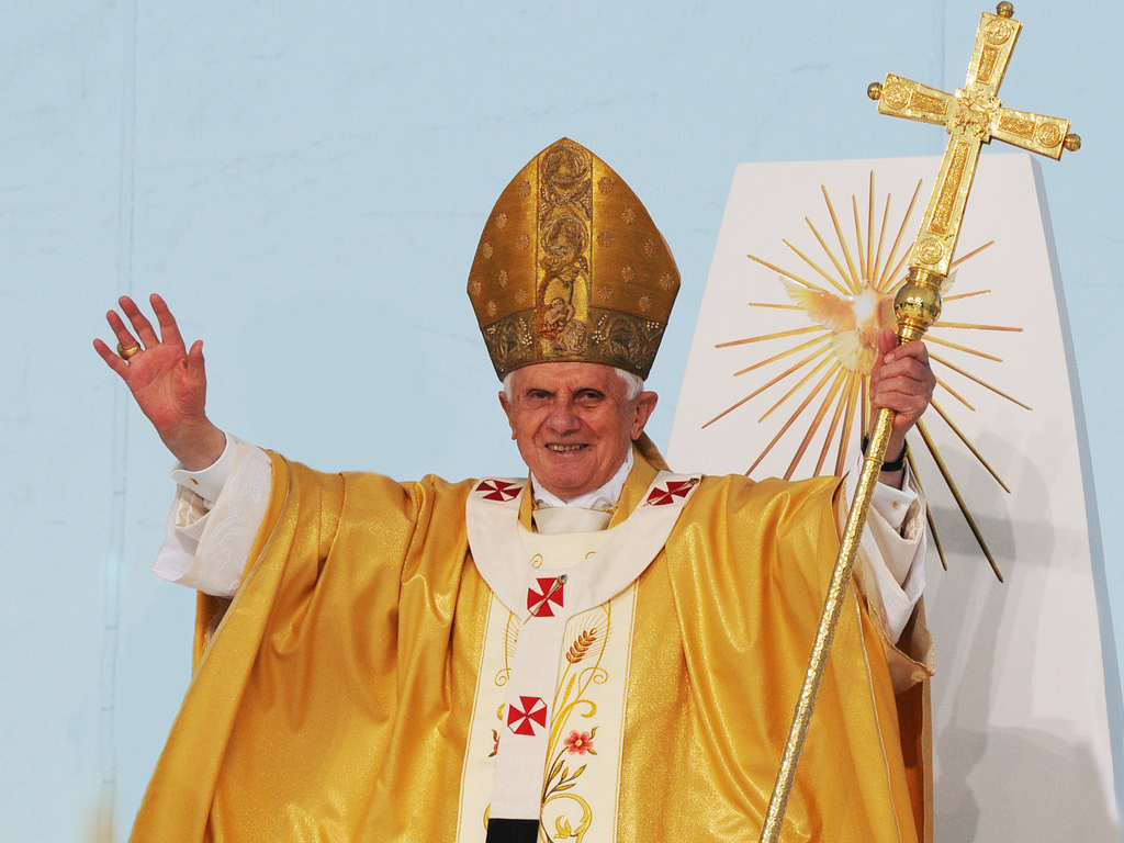 pope benedict xvi with hands raised and cross