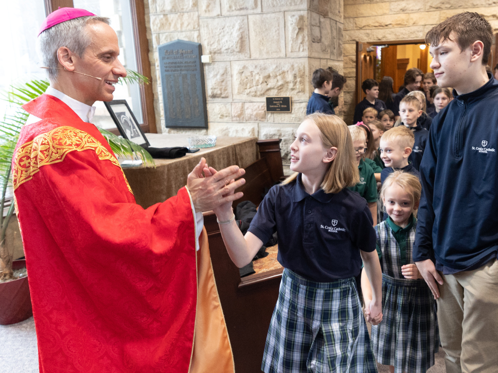 Bishop-elect Izen greets St. Croix Catholic Elementary students after celebrating Mass.