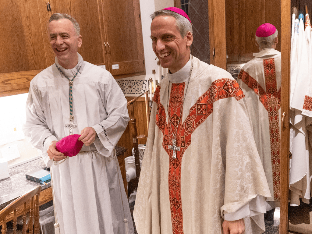 Bishop Joseph Williams and Bishop-elect Michael John Izen share a laugh as they prepare for the celebration of Mass at Church of St. Michael's in Stillwater, MN.