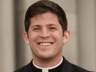 priest smiling at saint paul seminary