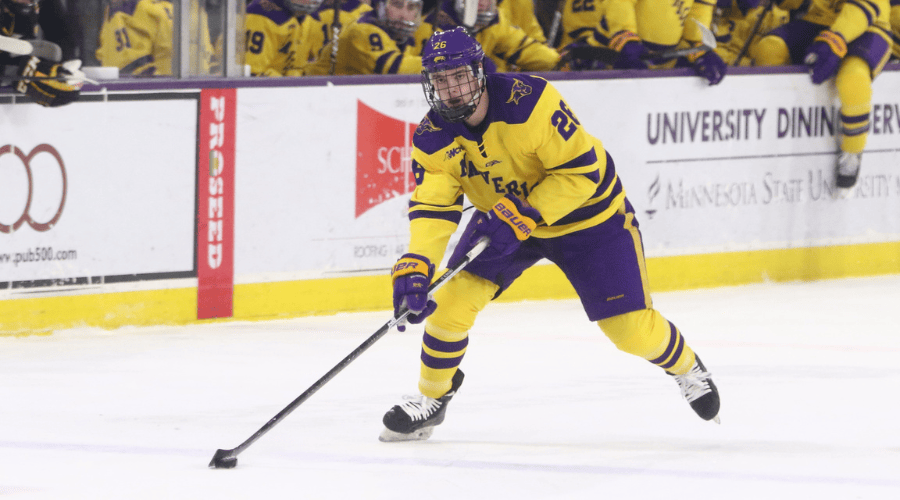 josh french carrying the puck up the ice for minnesota state hockey