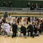 seminarians praying at center court at the 2024 de sales invitational basketball tournament