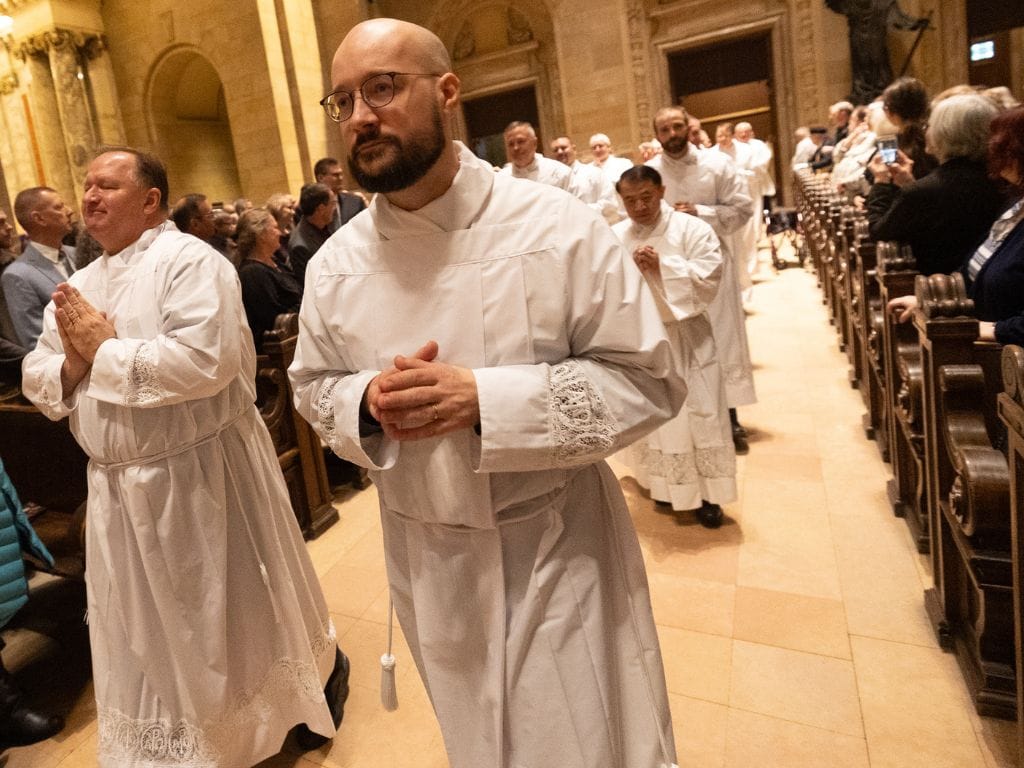 permanent deacon candidates processing into ordination mass