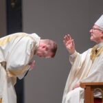 bishop robert barron blesses deacon josh miller before he preaches the Gospel at The Saint Paul Seminary
