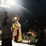 priest carries monstrance at national eucharistic congress