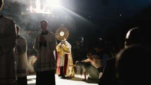 priest carries monstrance at national eucharistic congress