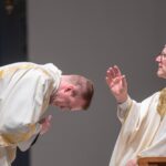 bishop robert barron blesses then-deacon josh miller before he reads the Gospel at Mass at The Saint Paul Seminary