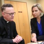 saint paul seminary health and wellness coordinator Susan Torborg meets with a Catholic priest