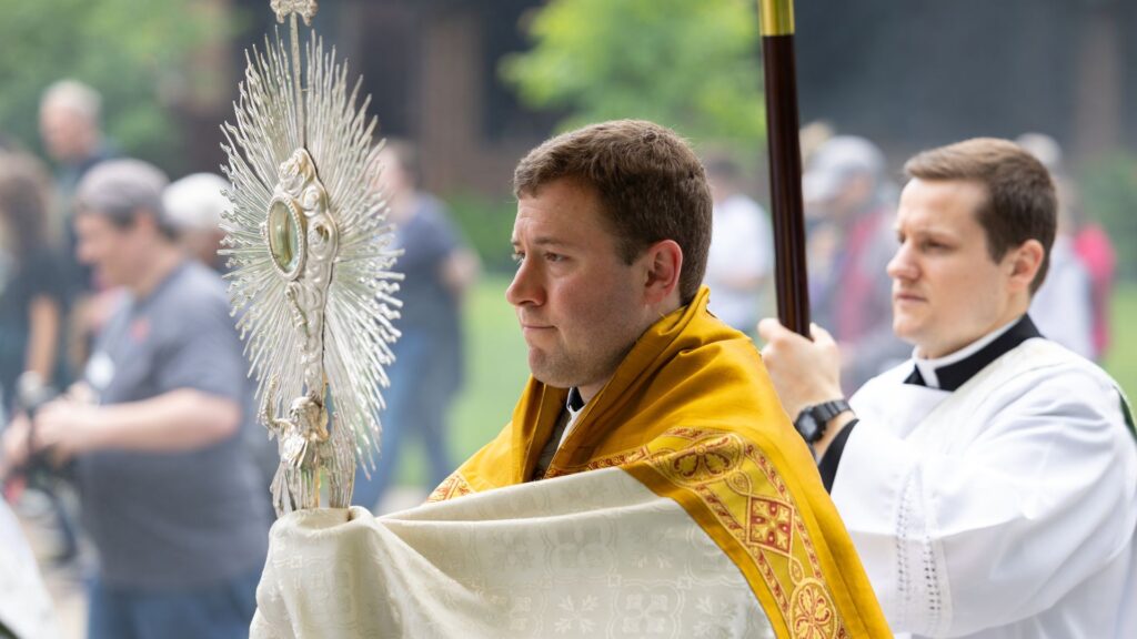 priest holding eucharistic monstrance