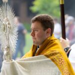 priest holding eucharistic monstrance