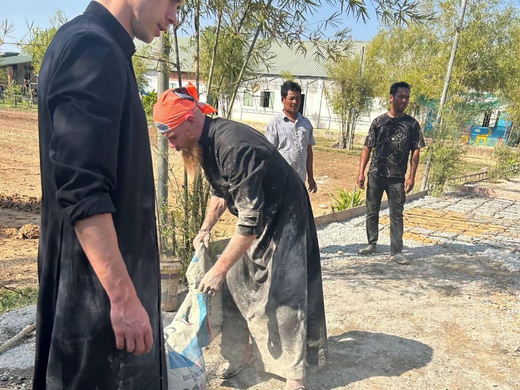 fr scott padrnos mixing concrete at a mission in cambodia