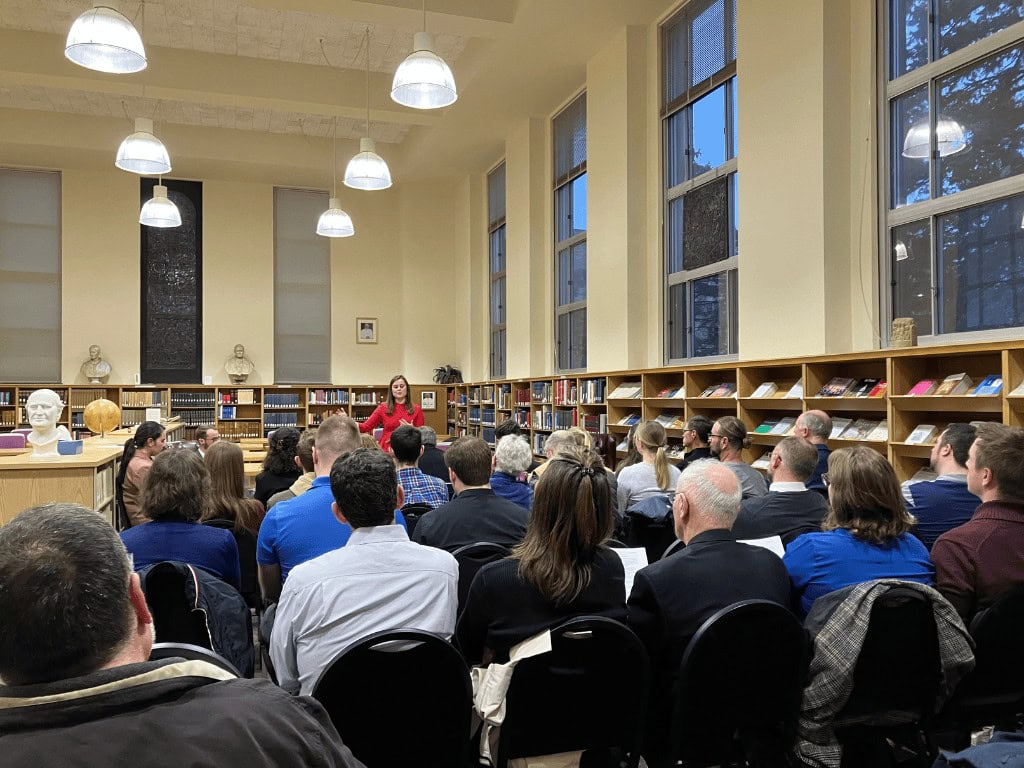 saint paul seminary lay student taylor croissant presents her theological research to a room full of people