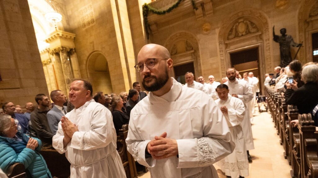 deacon candidates processing in for ordination mass