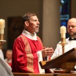 Catholic Deacons proclaiming the Gospel in Mass