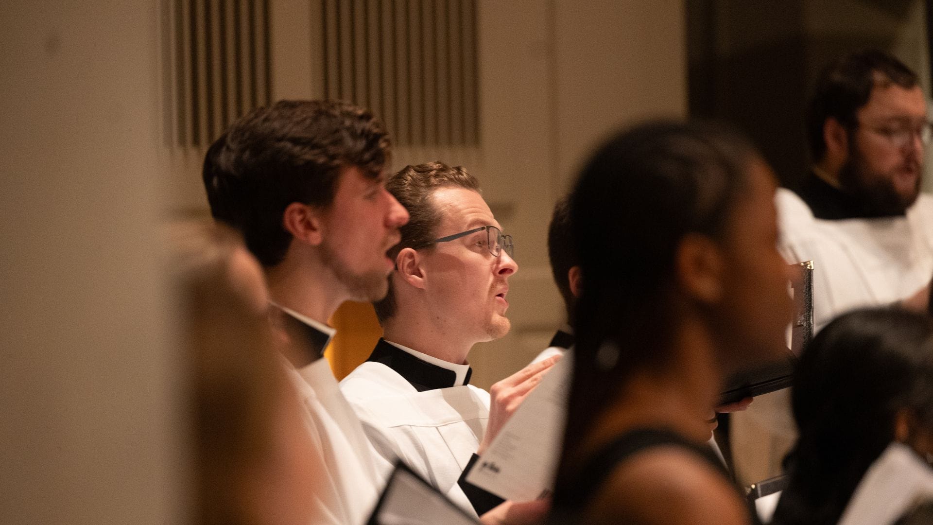 seminarian singing as part of mixed choir
